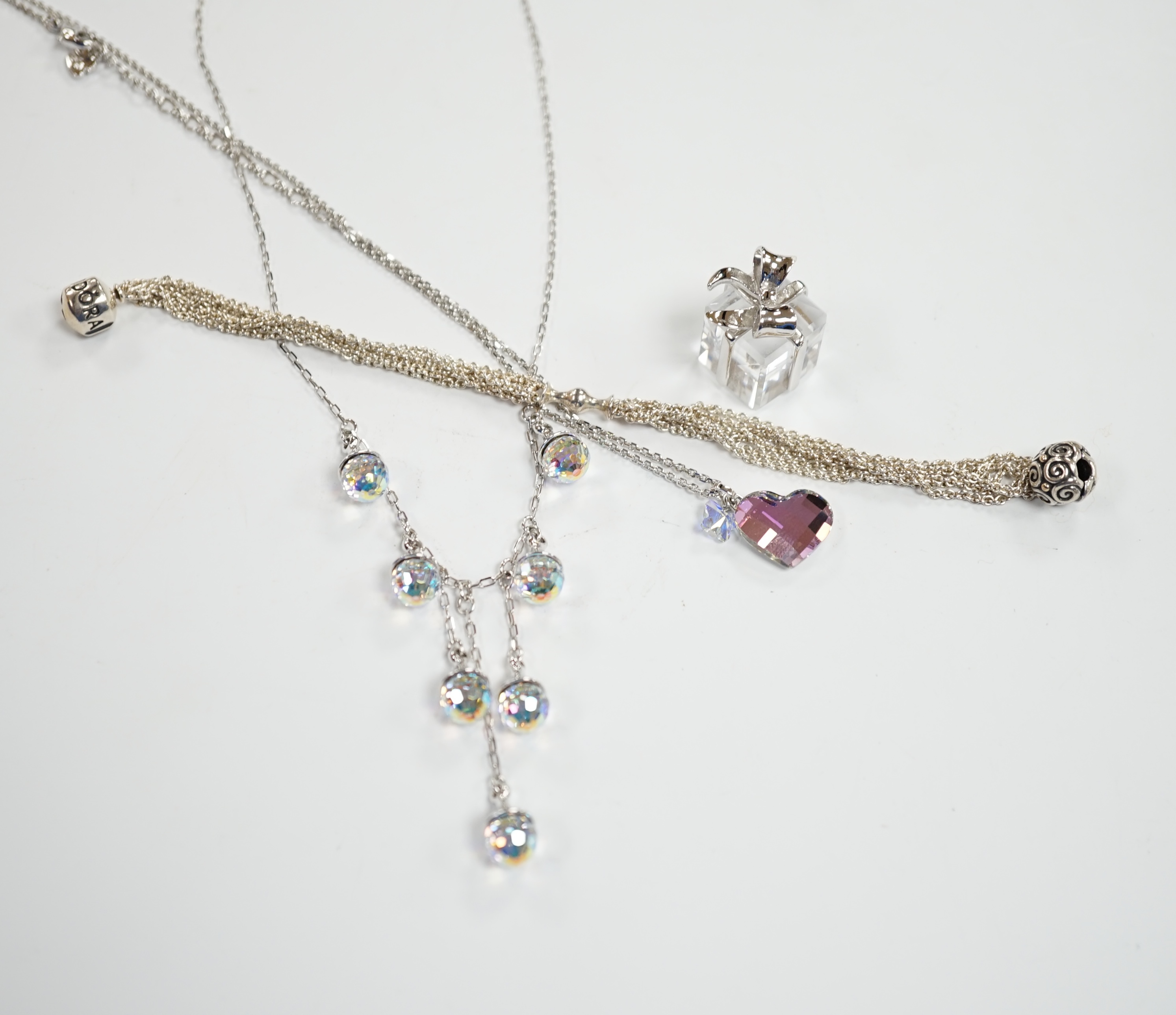 Two modern Swarovski crystal necklaces, a similar 'present' charm and a Pandora bracelet.